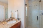 Granite countertops and hardwood cabinets add to the guest bathroom`s elegant design 